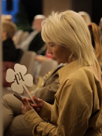 a woman holding an auction paddle