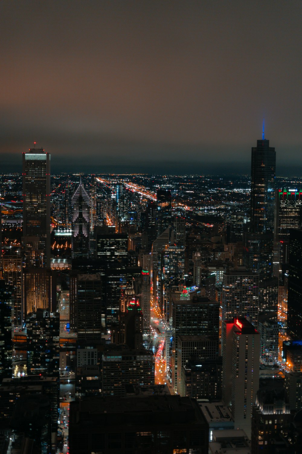 a view of a city at night from the top of a building