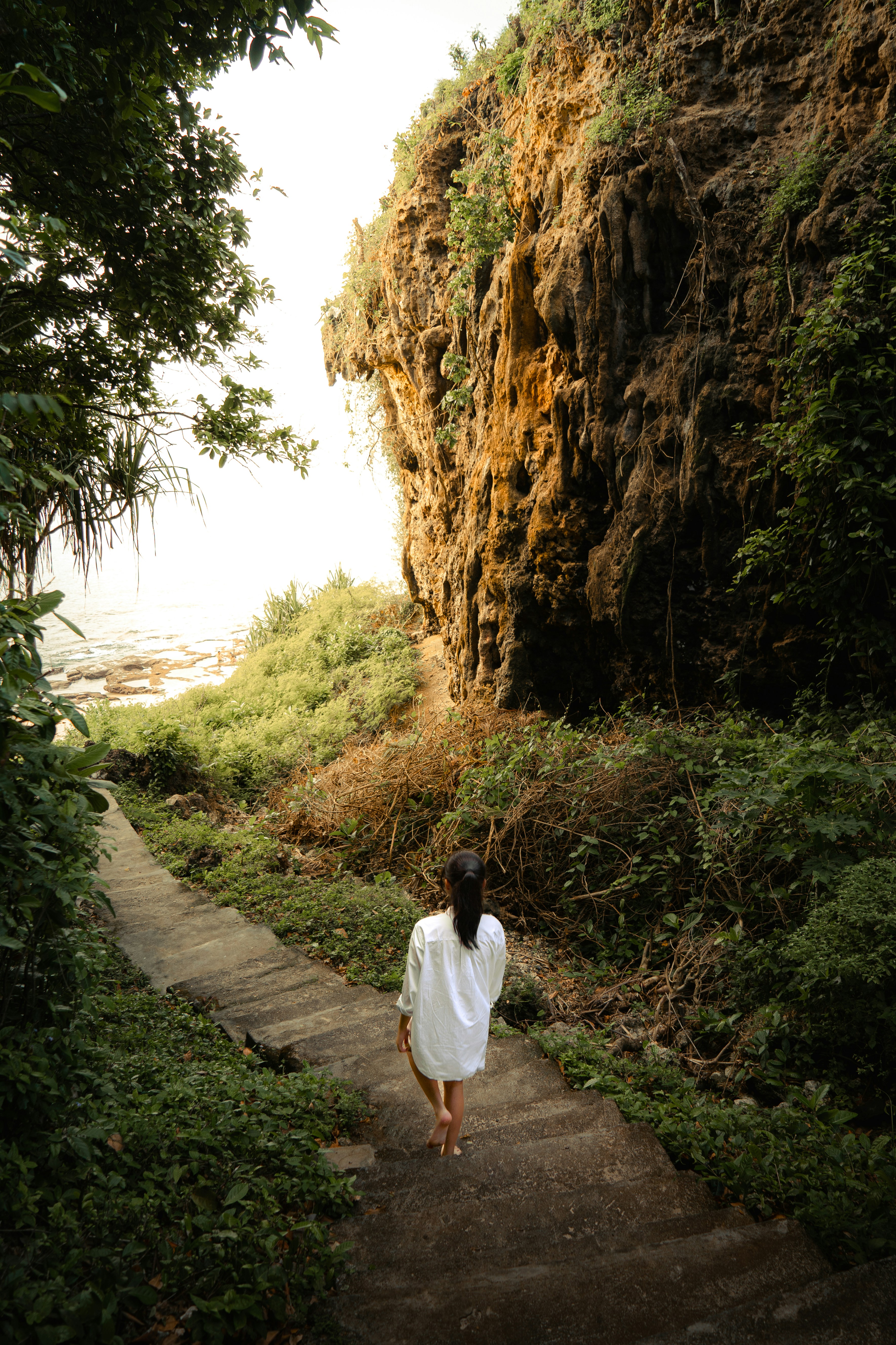 a woman is walking up a set of stairs