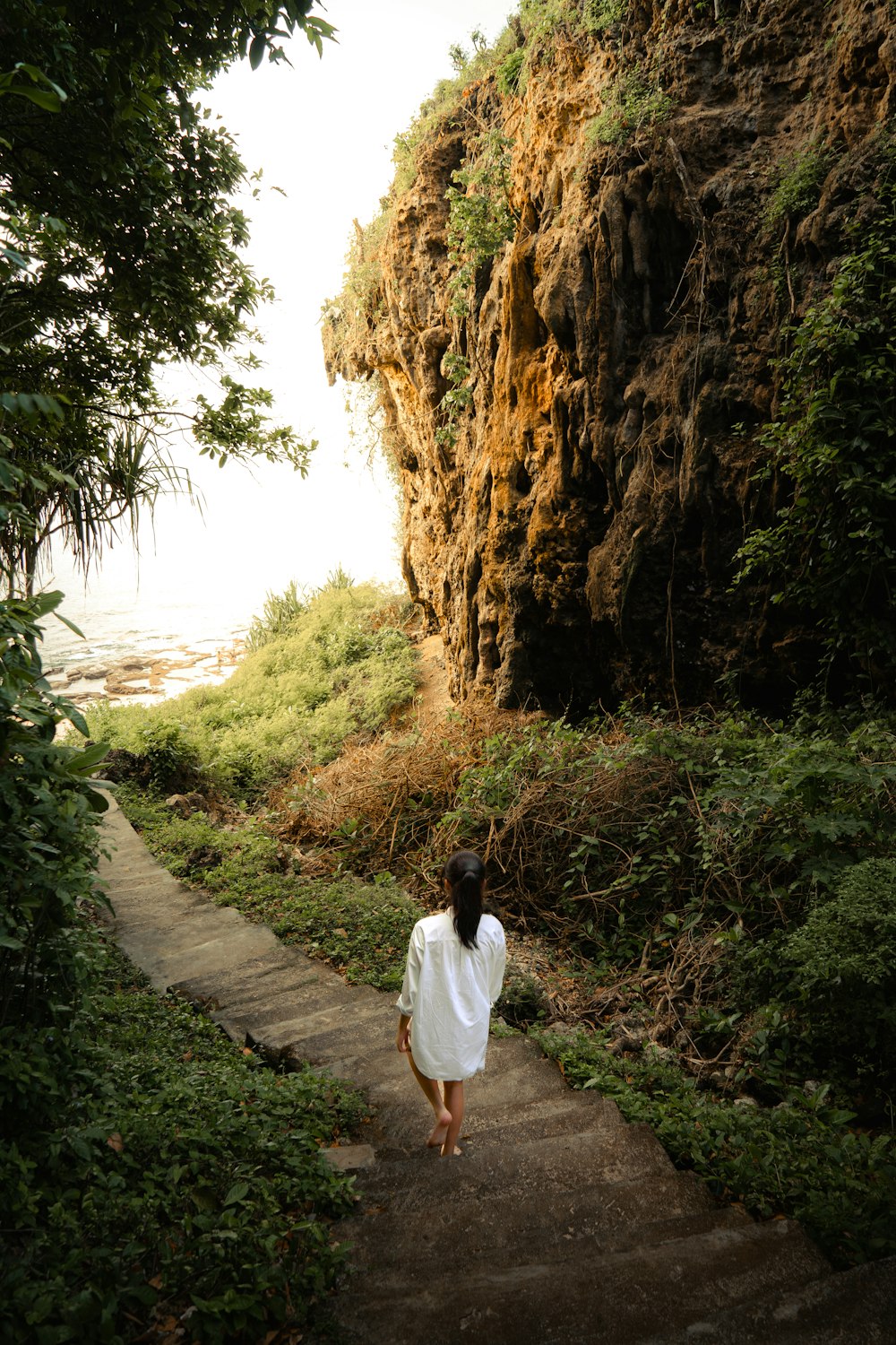 a woman is walking up a set of stairs