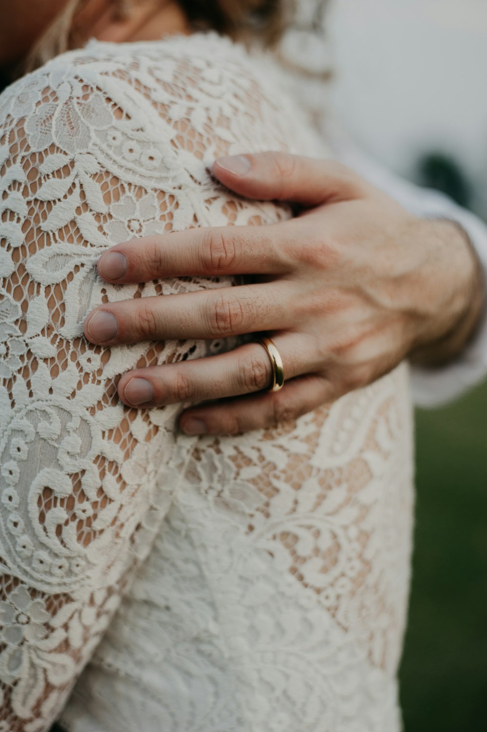 a close up of a person wearing a wedding ring