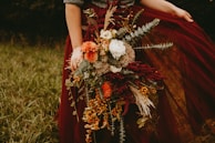 A seasonal bouquet featuring autumn leaves and flowers.