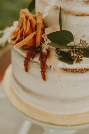 a close up of a wedding cake with flowers on it