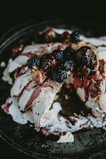 Decadent dessert with layers of cream and chocolate, topped with fresh berries