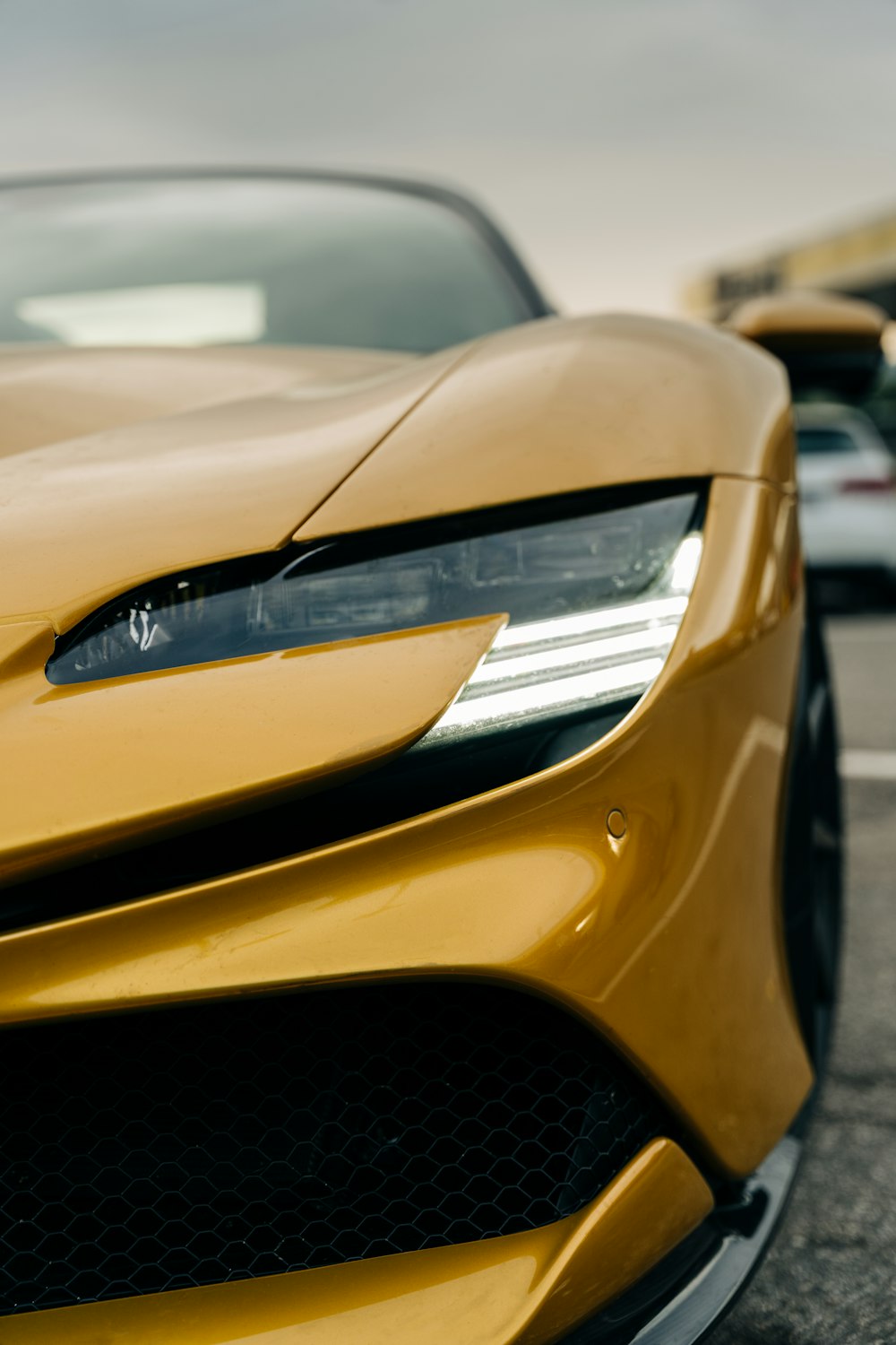 a yellow sports car parked in a parking lot