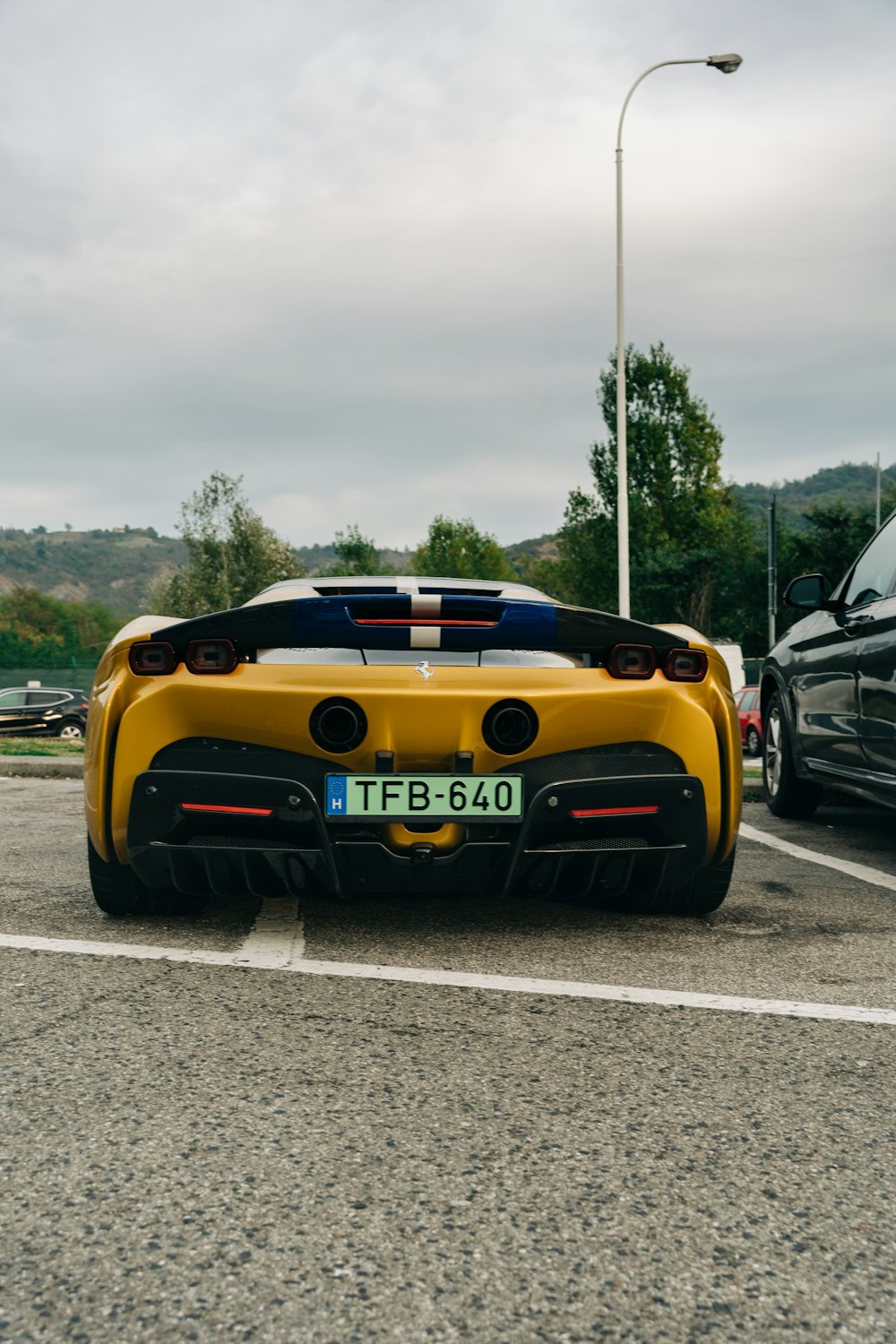 a yellow sports car parked in a parking lot