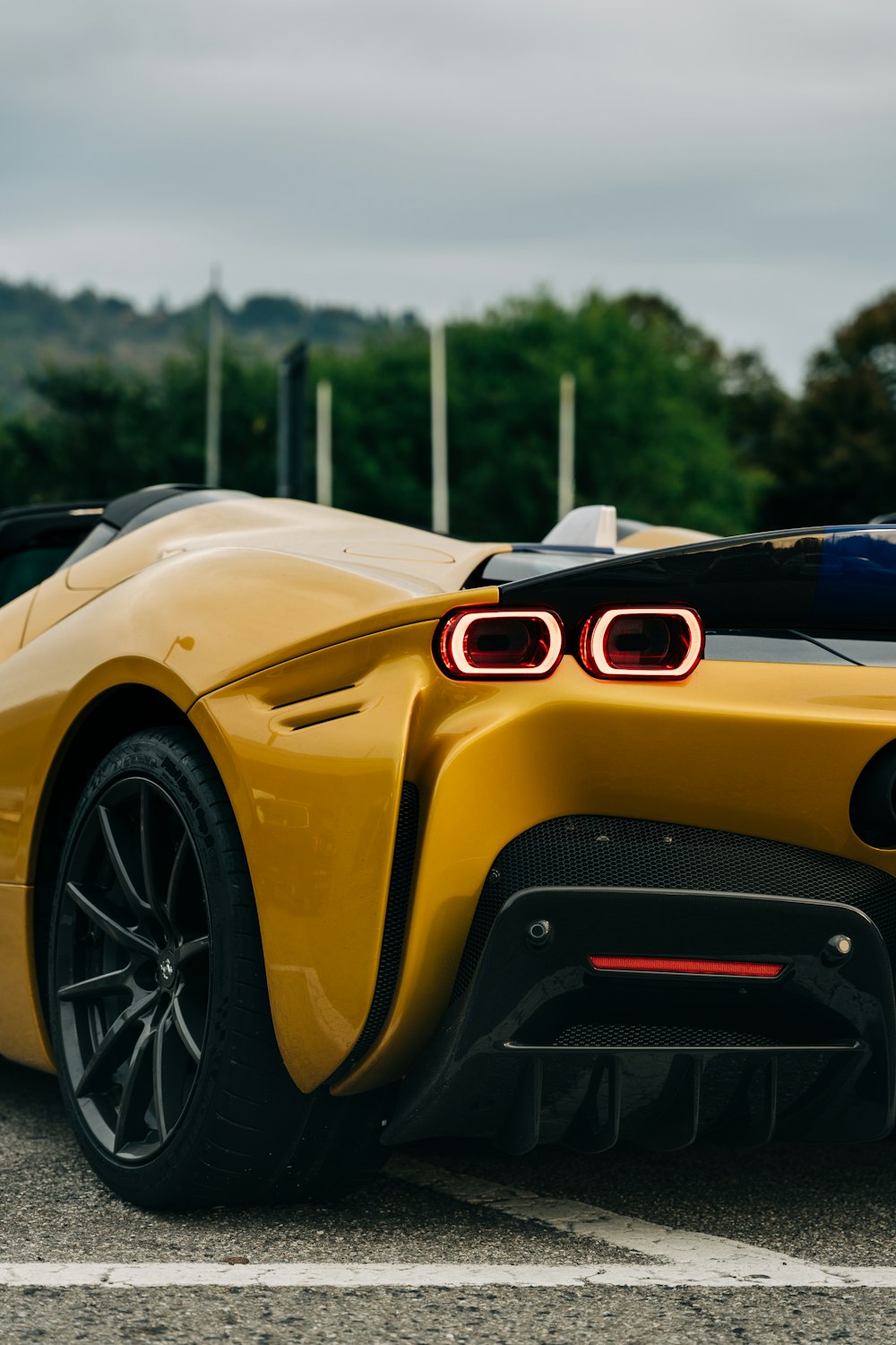 a yellow sports car parked in a parking lot