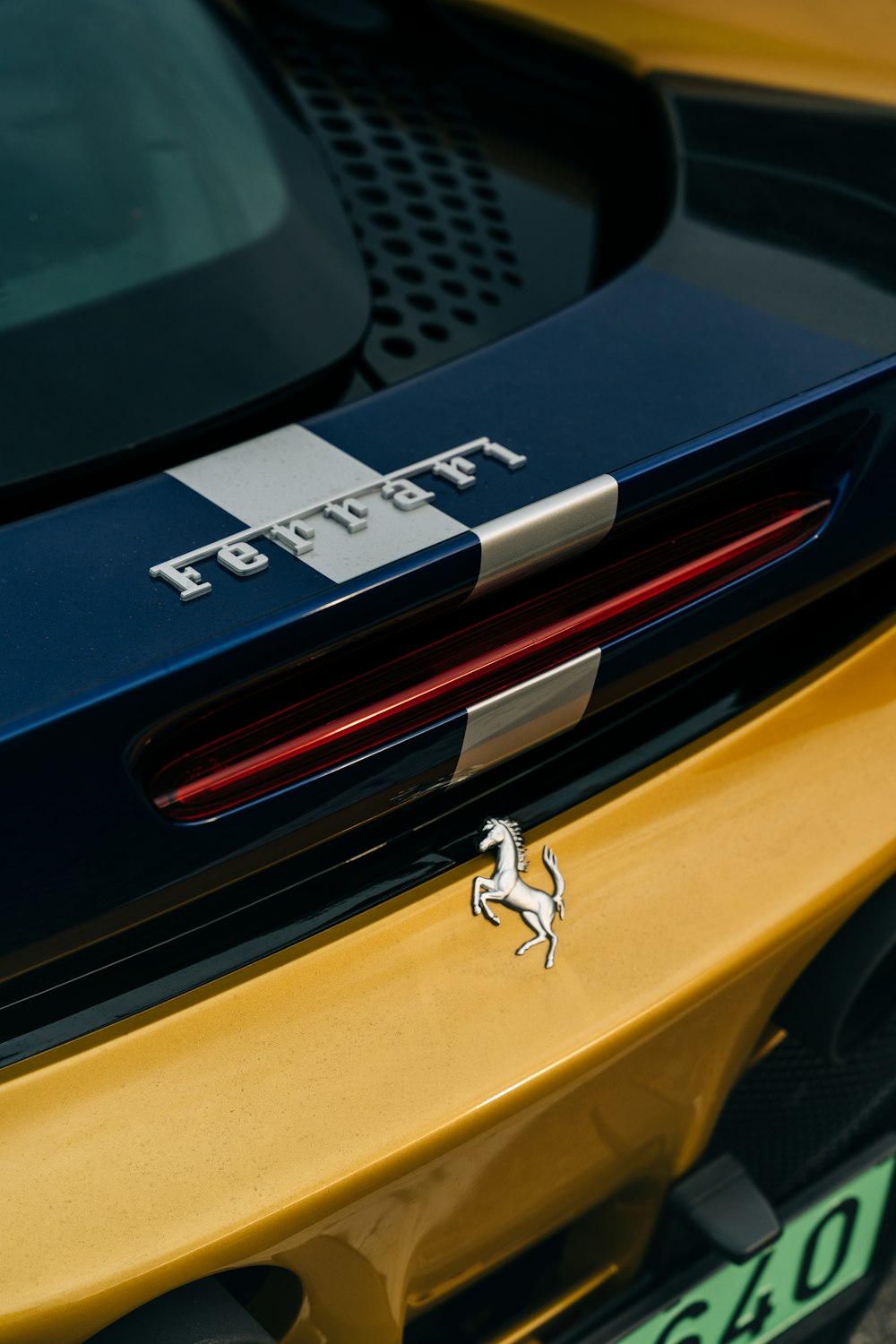 the rear end of a yellow and blue sports car