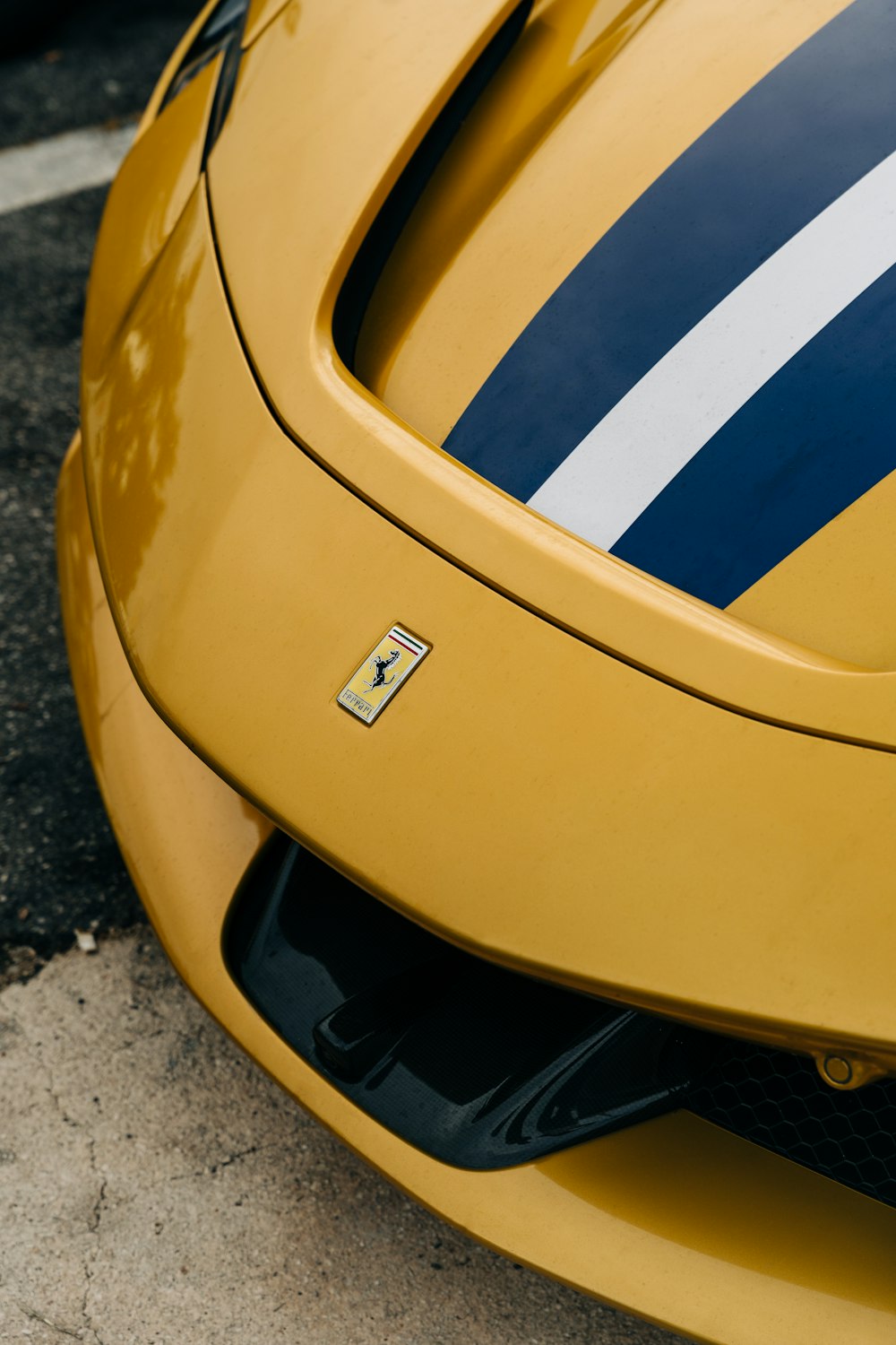 a close up of the front of a yellow sports car