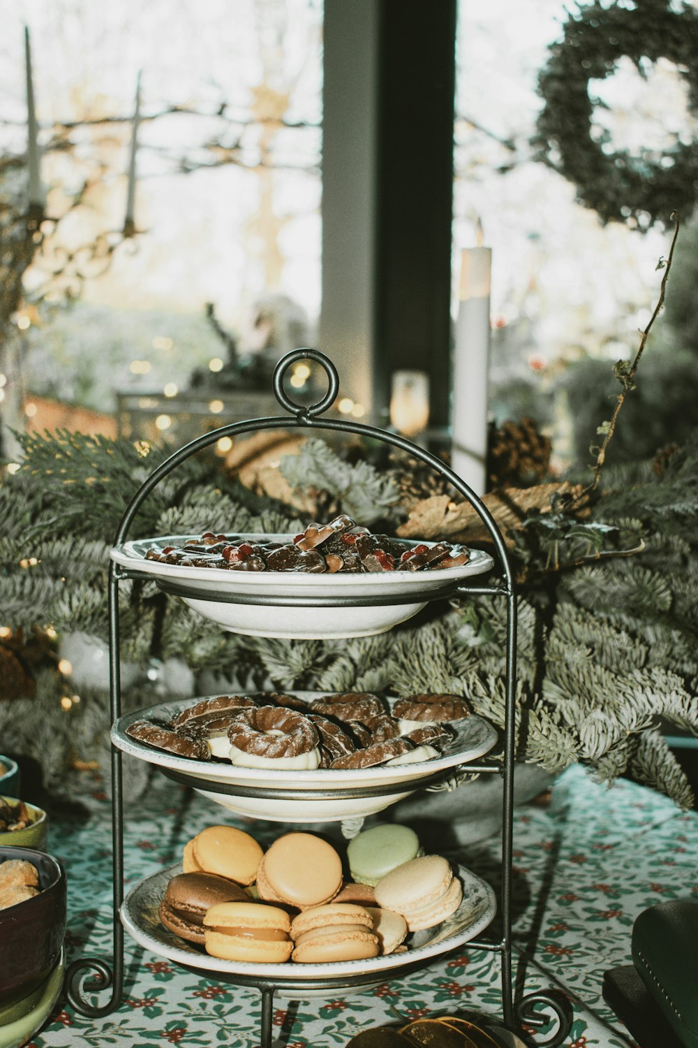 three tiered trays of cookies and pastries on a table
