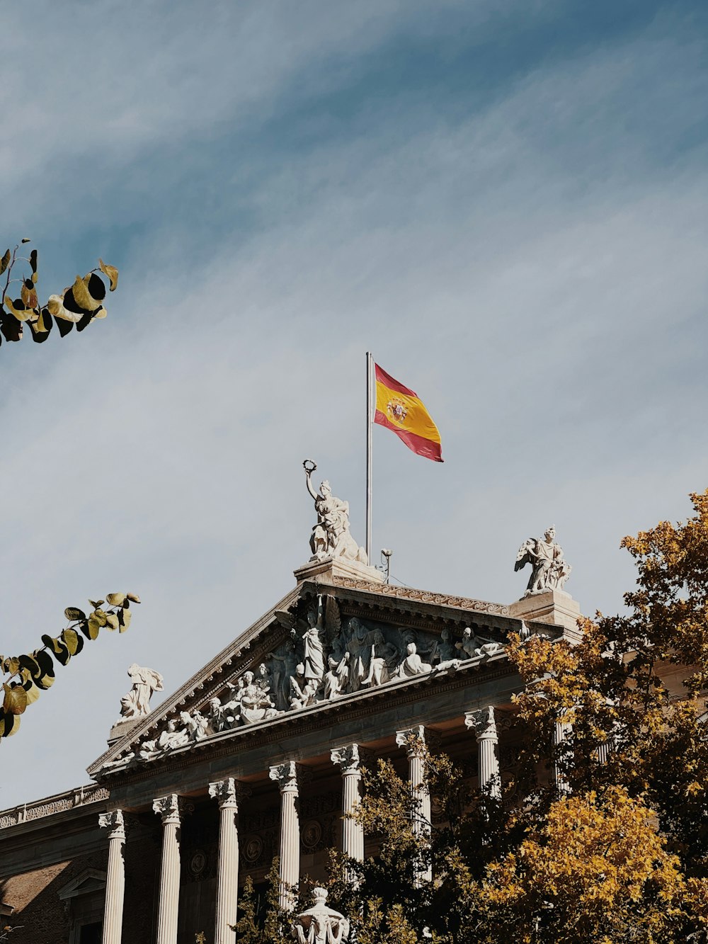 a flag on top of a building with columns