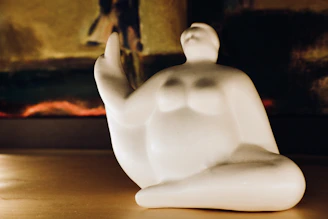 A detailed 3D printed sculpture of an abstract human figure with smooth curves and a matte finish.