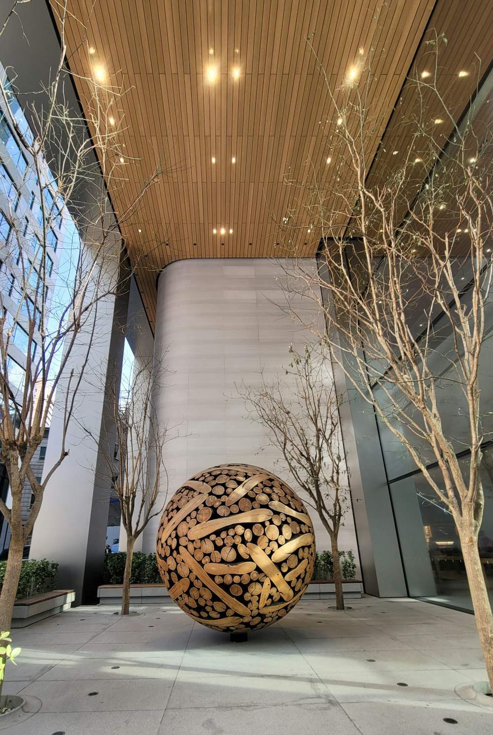 a large ball sitting in the middle of a courtyard