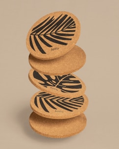 Elegant wooden coasters with intricate designs stacked neatly.