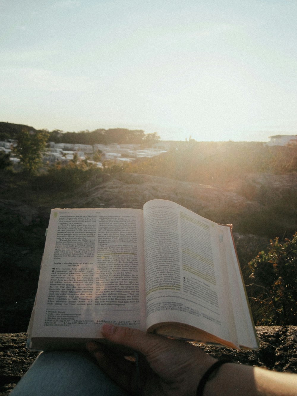 a person holding an open book in their hands