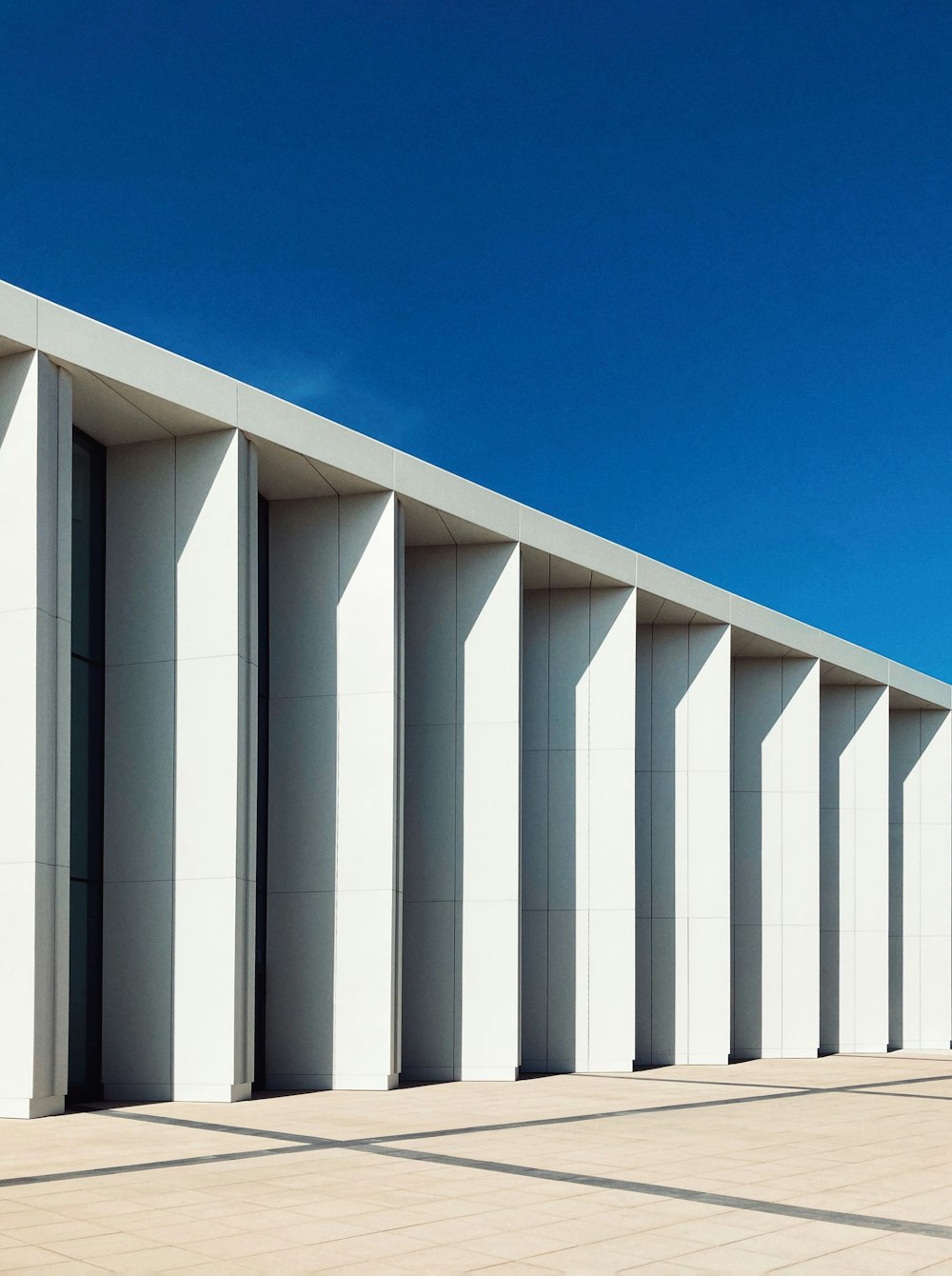 a row of white buildings with a blue sky in the background