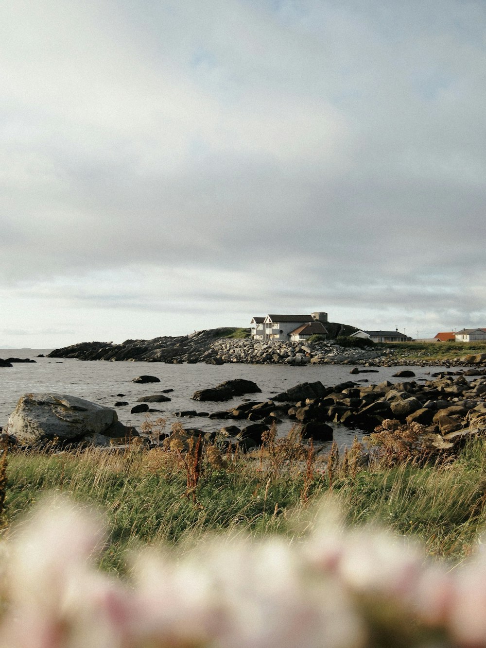 a lighthouse on a rocky shore near a body of water