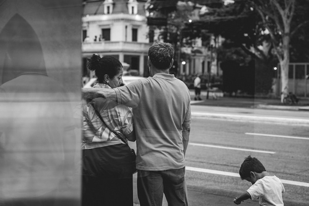 a black and white photo of a man and two children