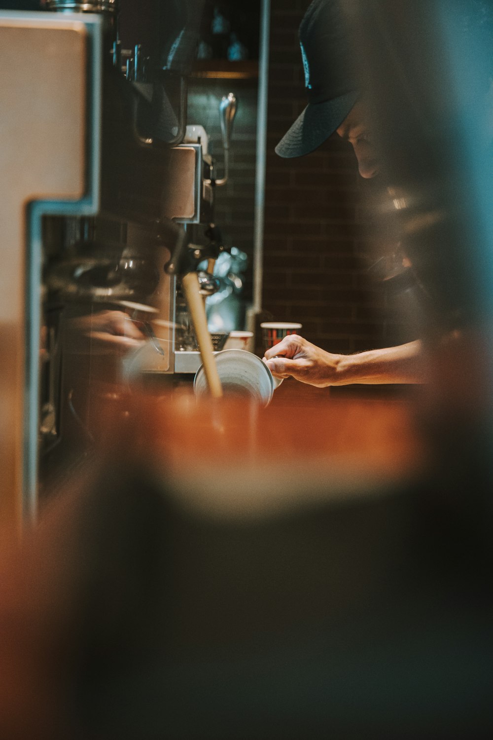 a person working on a machine in a coffee shop