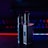 Two metallic vape devices are positioned in the foreground with a sleek design and buttons on their bodies. The background is a blur of colorful lights, featuring tones of blue and red, suggesting a digital or gaming environment.