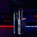 Two metallic vape devices are positioned in the foreground with a sleek design and buttons on their bodies. The background is a blur of colorful lights, featuring tones of blue and red, suggesting a digital or gaming environment.