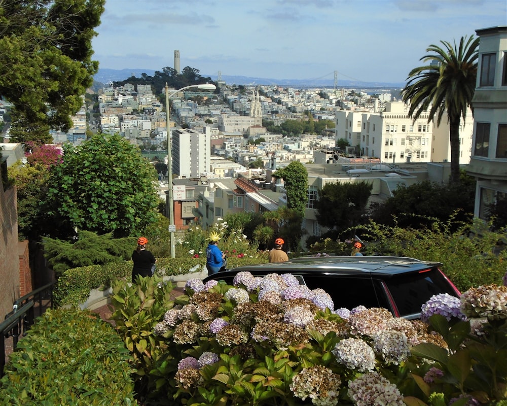 a car parked on the side of a hill with a city in the background