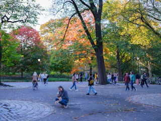 A smiling family happily exploring a Canadian city park during autumn