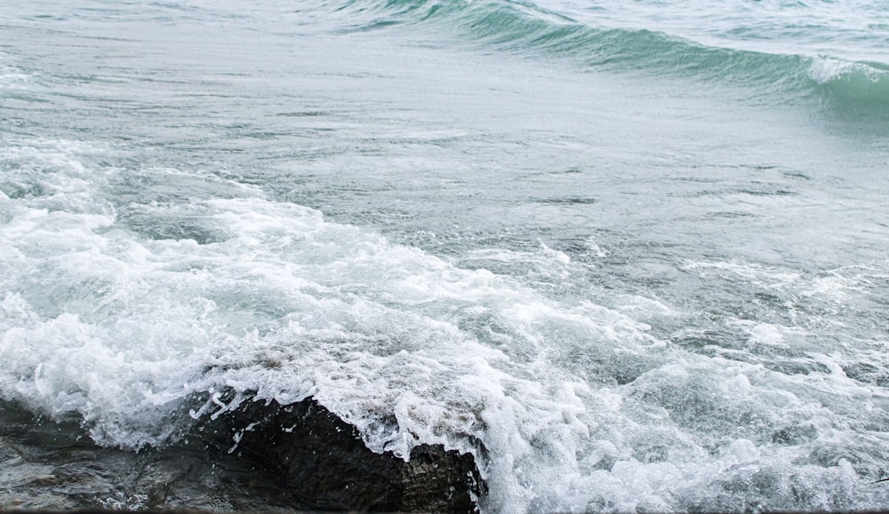 a person riding a surfboard on top of a wave