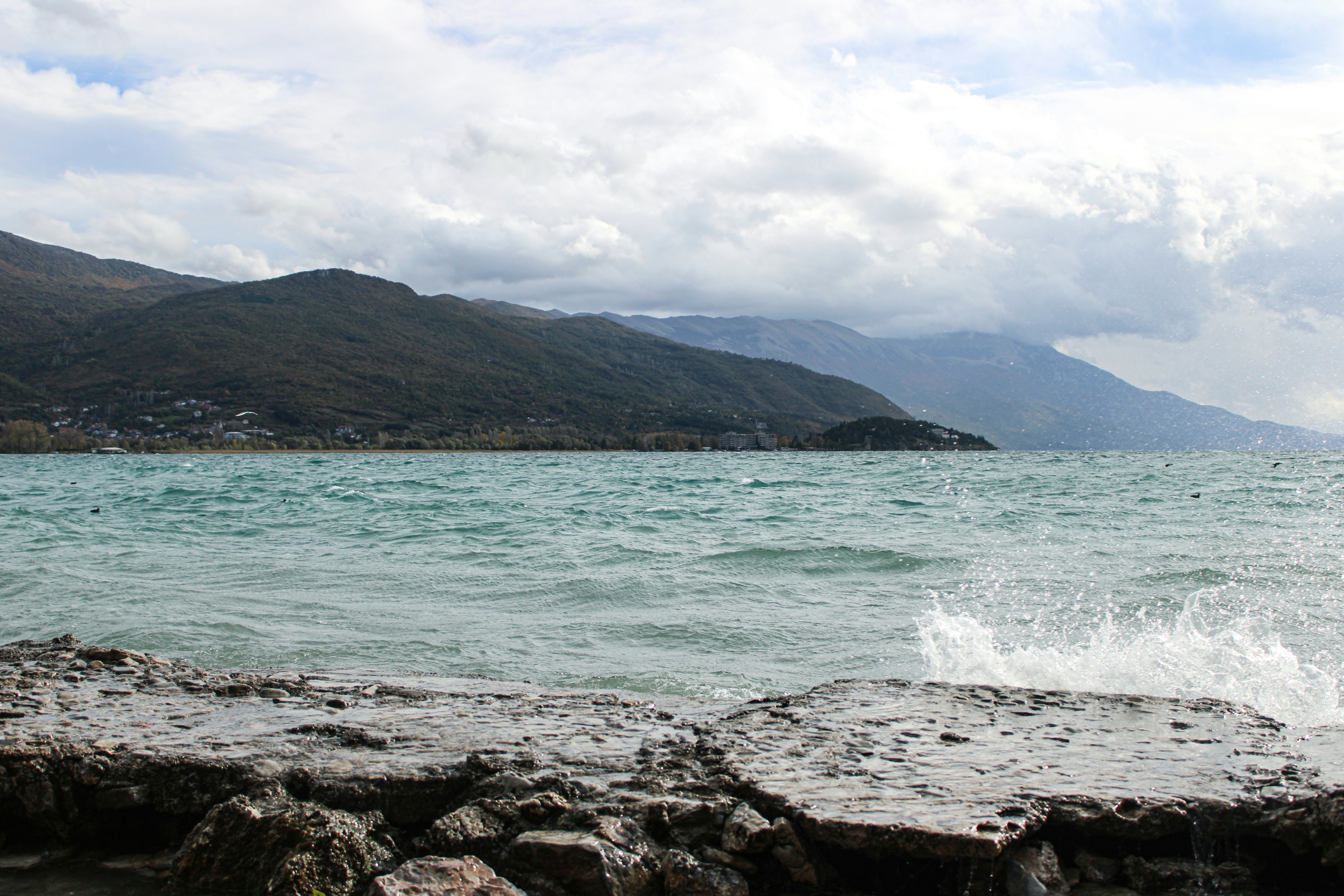 a body of water with mountains in the background