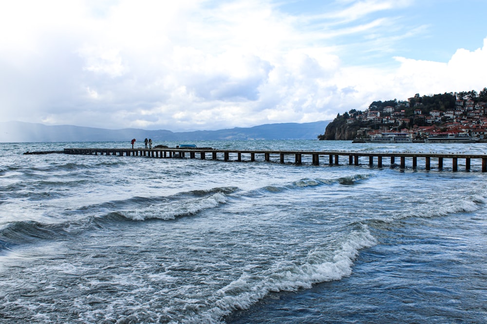 a body of water with a pier in the middle of it