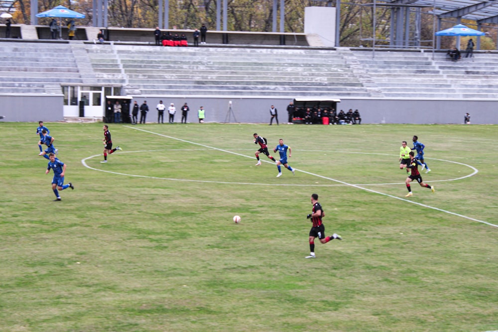 a group of men playing a game of soccer on a field