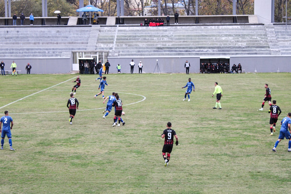 a group of men playing a game of soccer