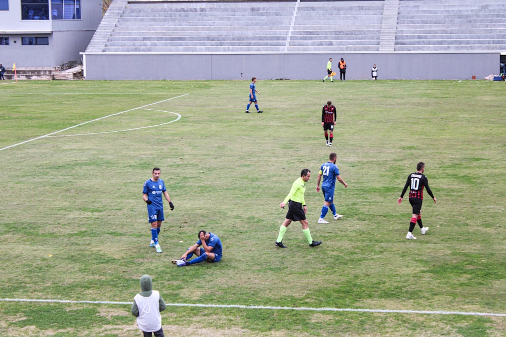 a group of men playing a game of soccer