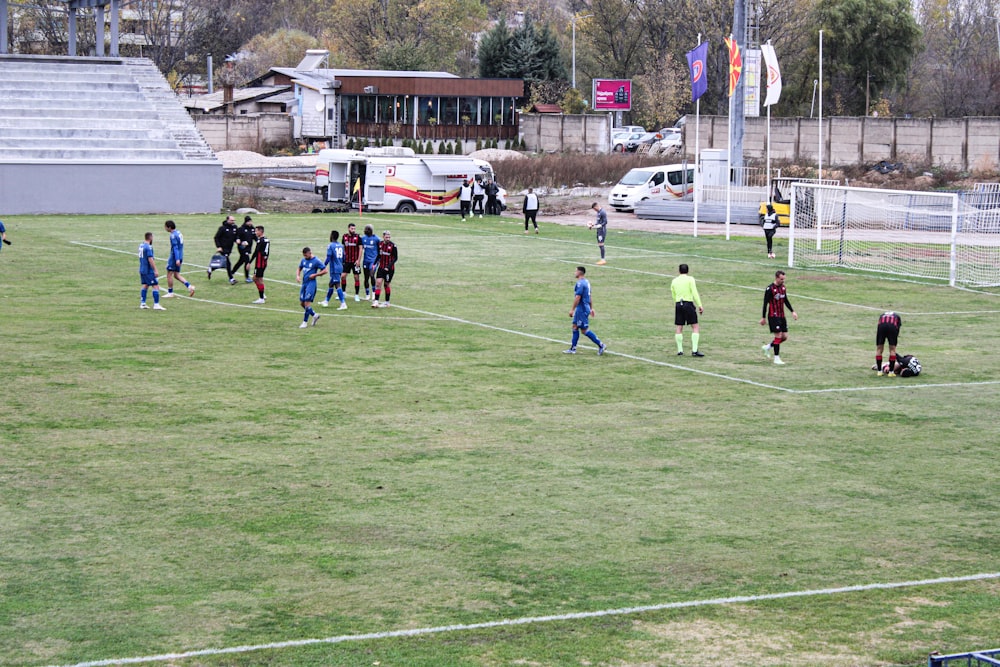 a group of people standing on top of a soccer field