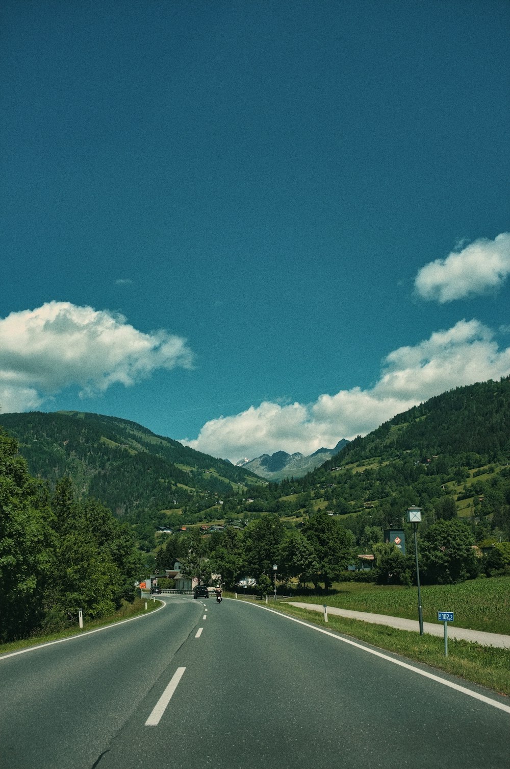 a view of a road with mountains in the background