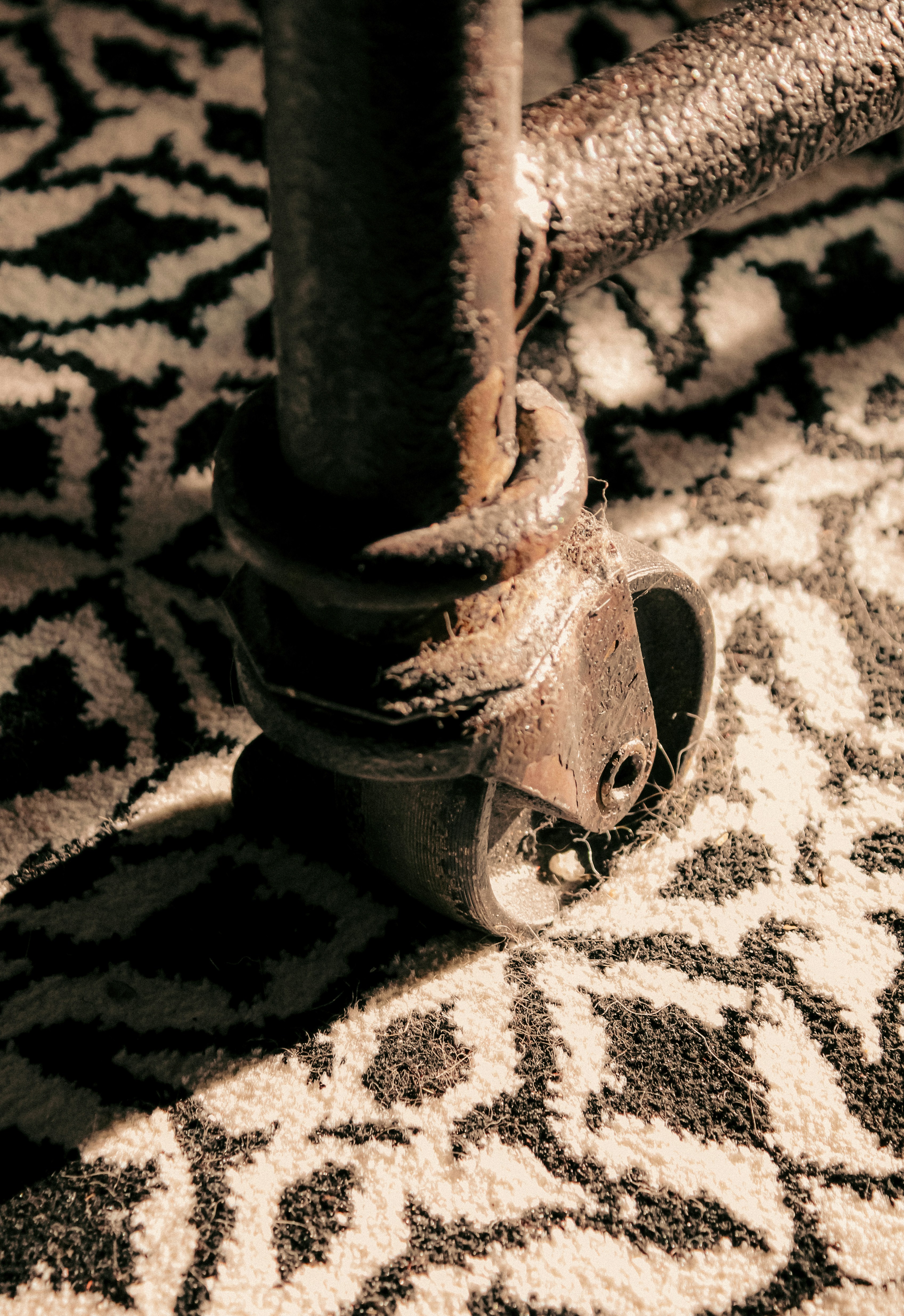 wheel of table leg on patterned rug