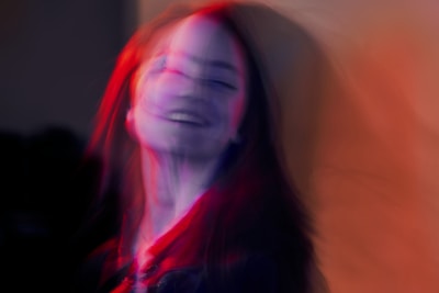 A colorful digital portrait of a woman with flowing hair and abstract shapes.