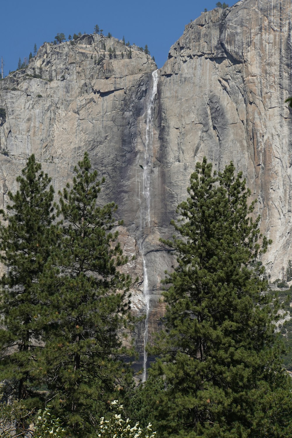 a tall mountain with a waterfall coming out of it