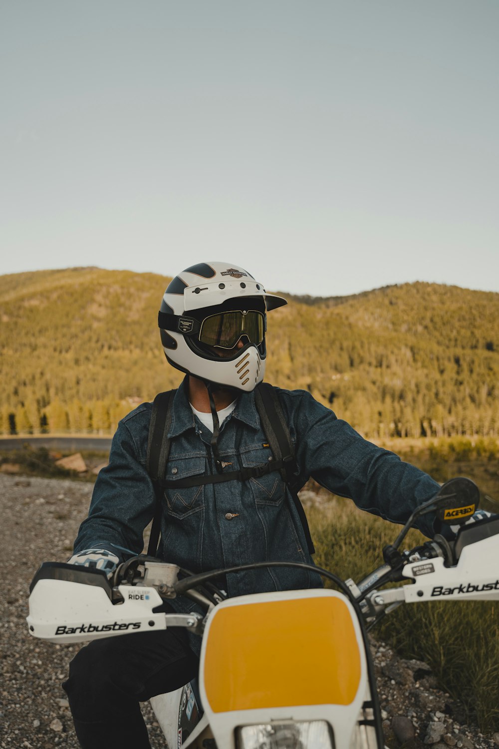 a man wearing a helmet sitting on a motorcycle