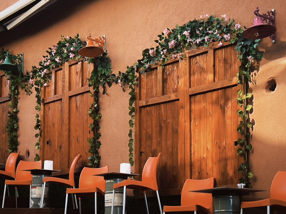 a row of orange chairs sitting in front of a building