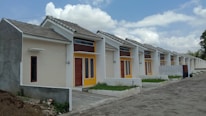 A neat row of residential rental homes in Orlando under bright blue skies.