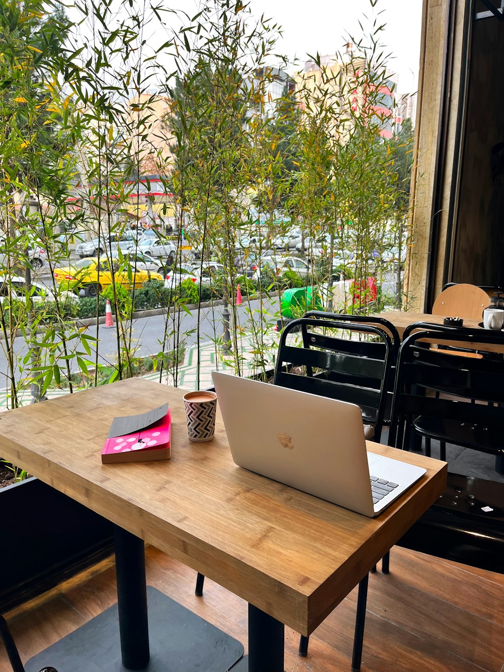 a laptop computer sitting on top of a wooden table