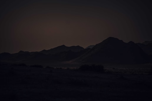 A dark-themed space scene with mountains in the foreground.
