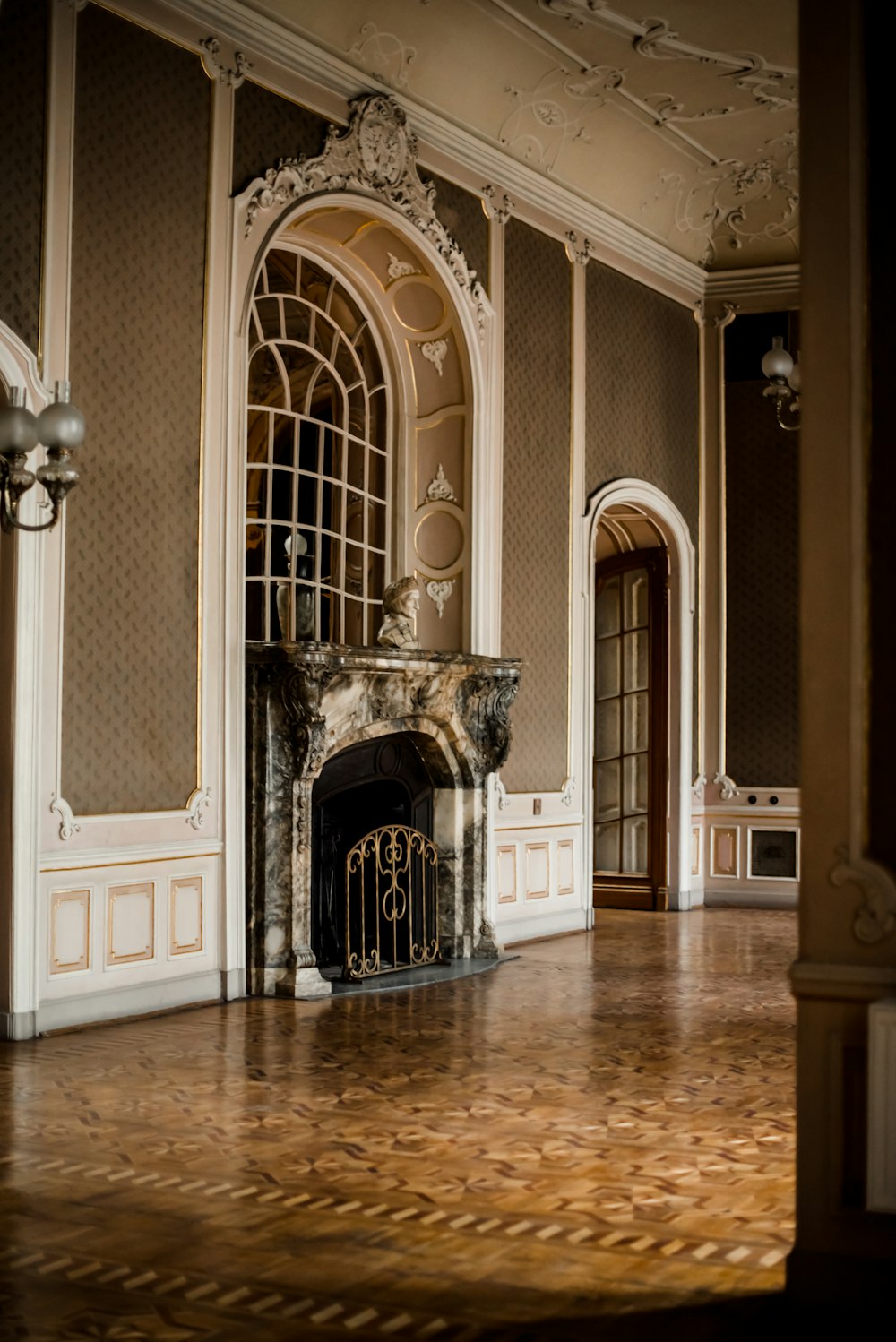 a large room with a fireplace and a wooden floor