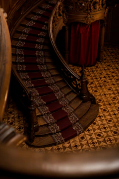 Close-up of a custom stair runner with intricate patterns in a warm, elegant hallway.