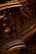 Intricate wooden carvings with swirling patterns, likely part of an ornate piece of furniture or architecture. The design showcases detailed craftsmanship with a focus on elegant curves and textures.