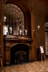 A beautifully hung picture frame above a fireplace.