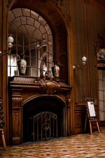 Elegant white wooden mantel with intricate carvings in a cozy living room