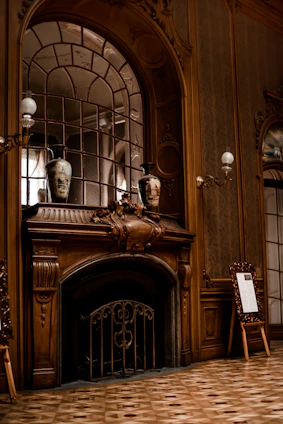 Elegant white wooden mantel with intricate carvings in a cozy living room