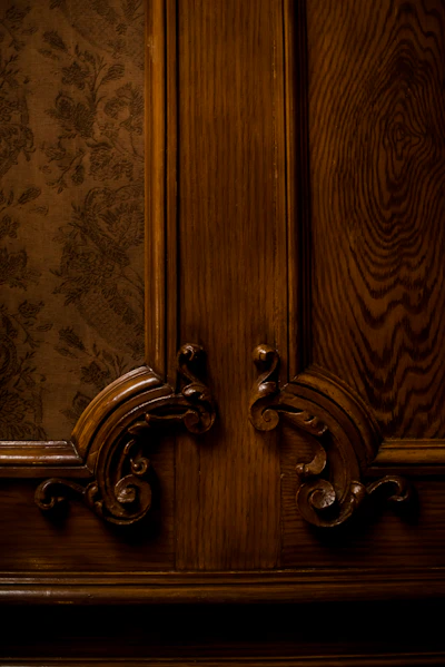a close up of a wooden door with a fancy handle